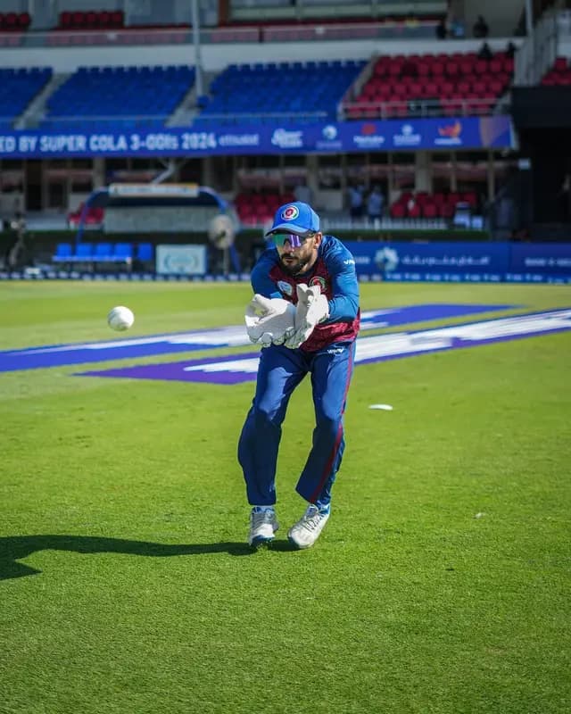 Wicketkeeper catching the ball during a specialist keeping masterclass