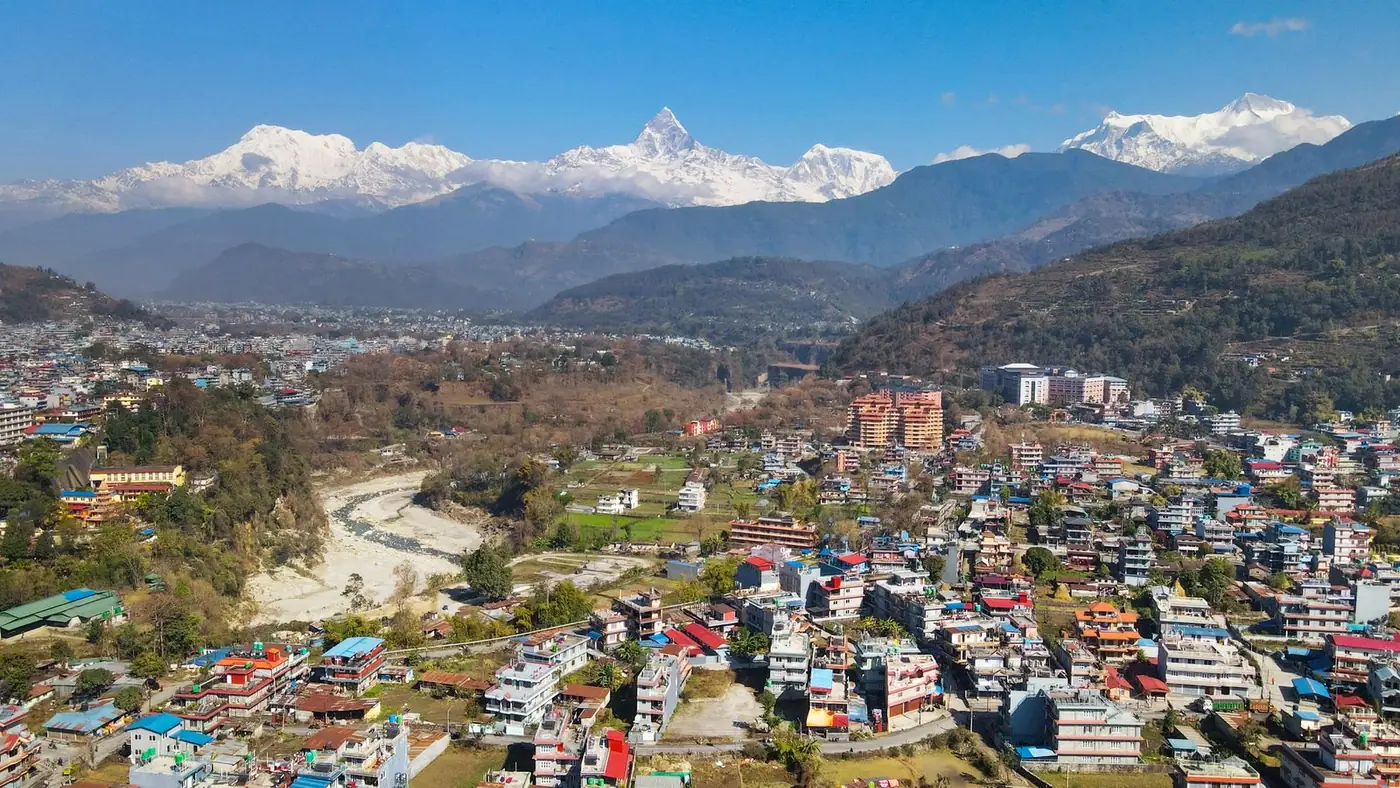Pokhara, Nepal, seen from above with the Himalayas rising behind the town
