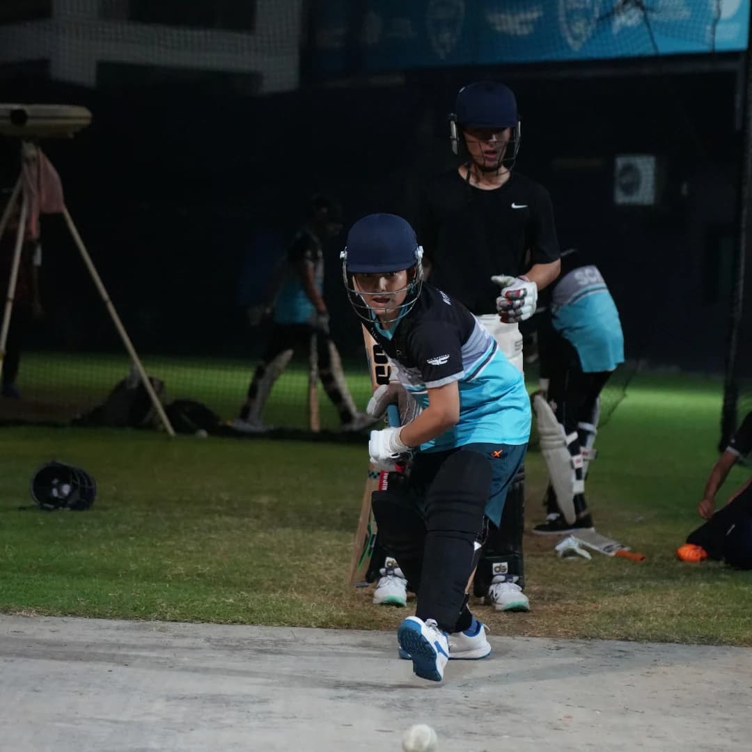 Young cricketer keeping a close eye on the ball during a batting drill