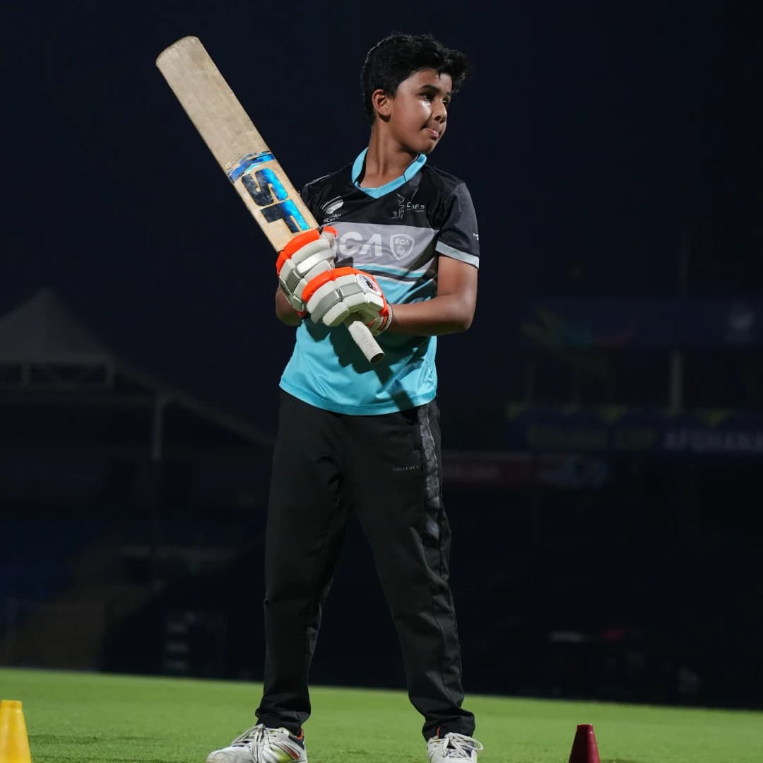 Young cricketer in full kit ready to take the field