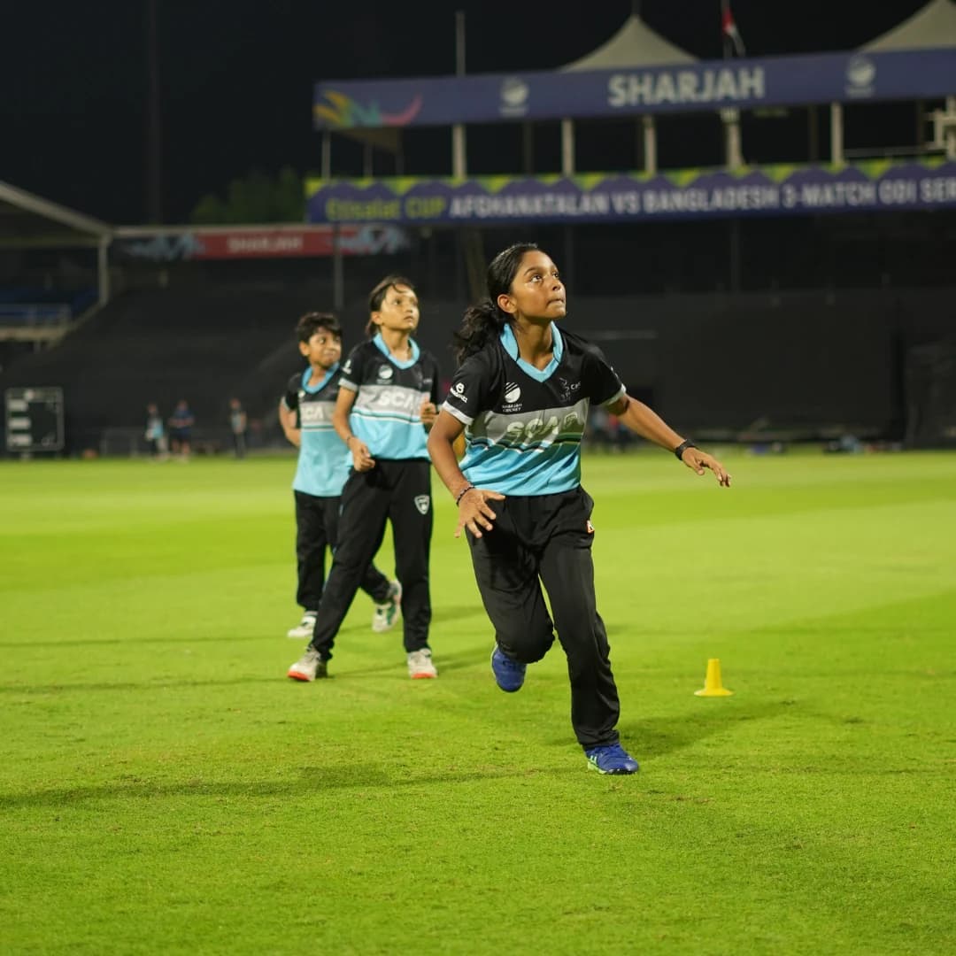 Young bowler mid-delivery stride during a bowling drill