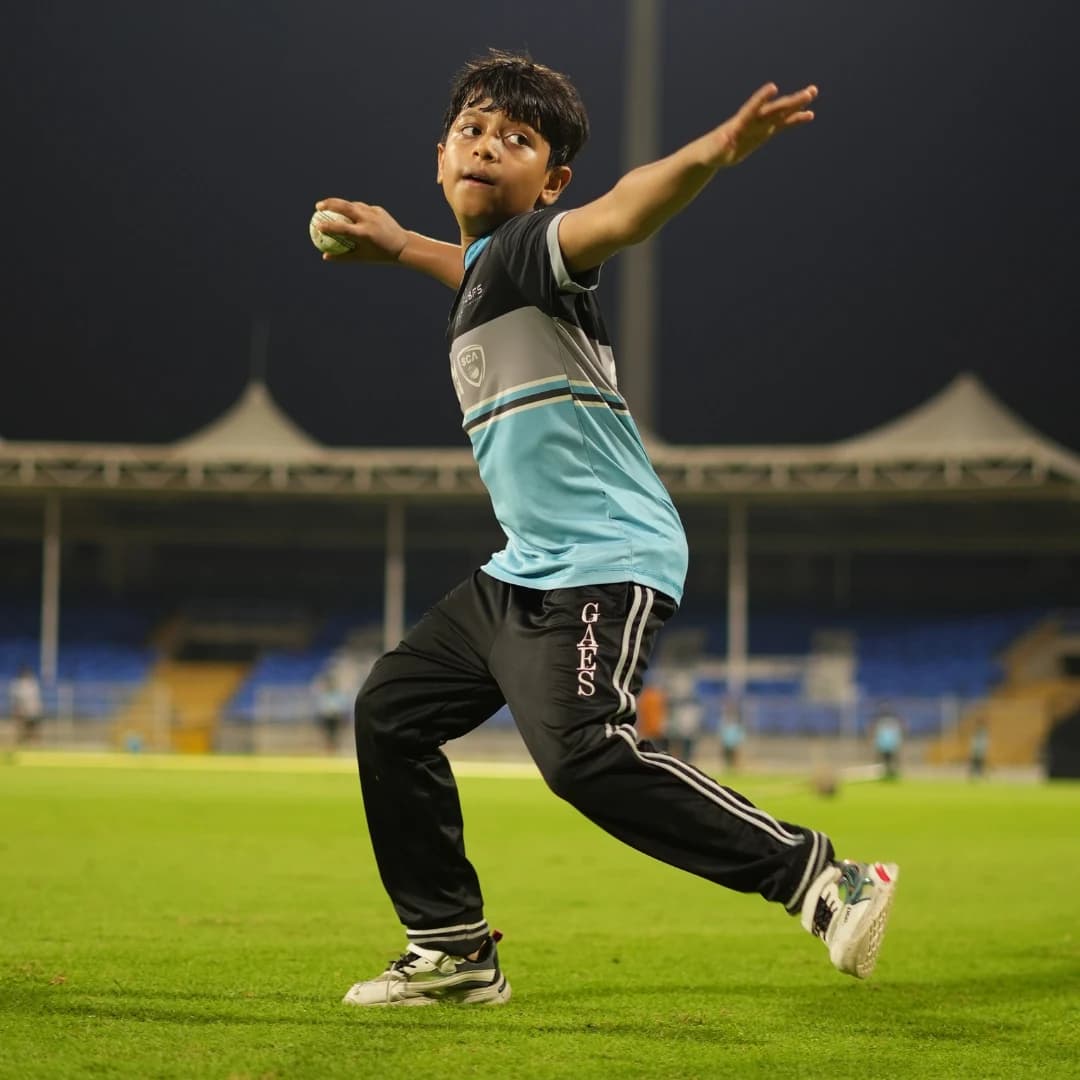 Young fast bowler following through after delivery