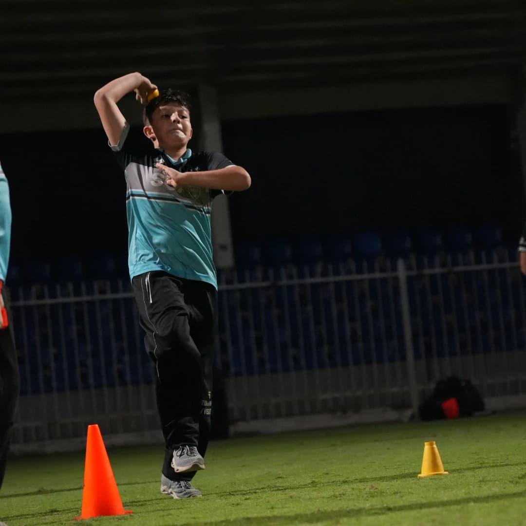 Young bowler practicing their action in the nets