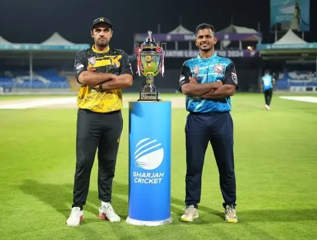 Two opposing team captains posing with the trophy before the final at Sharjah Cricket Stadium