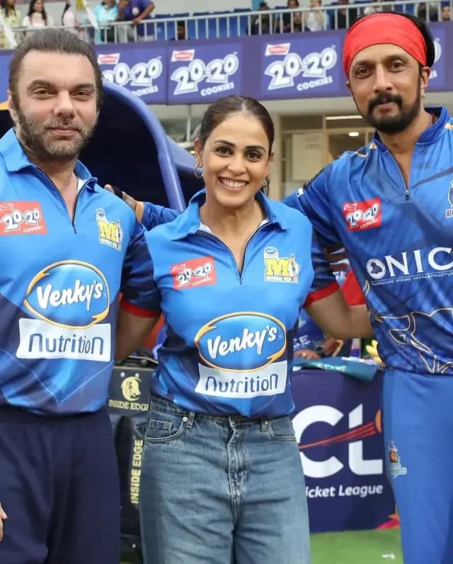 Three celebrity guests posing together in team jerseys